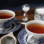 drinking tea black from blue china tea cups