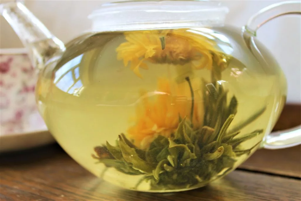 glass teapot with blooming green tea