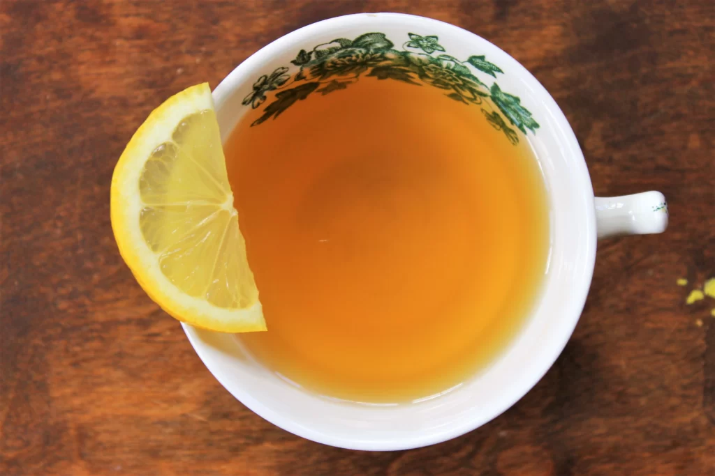 teacup of green tea with a lemon slice