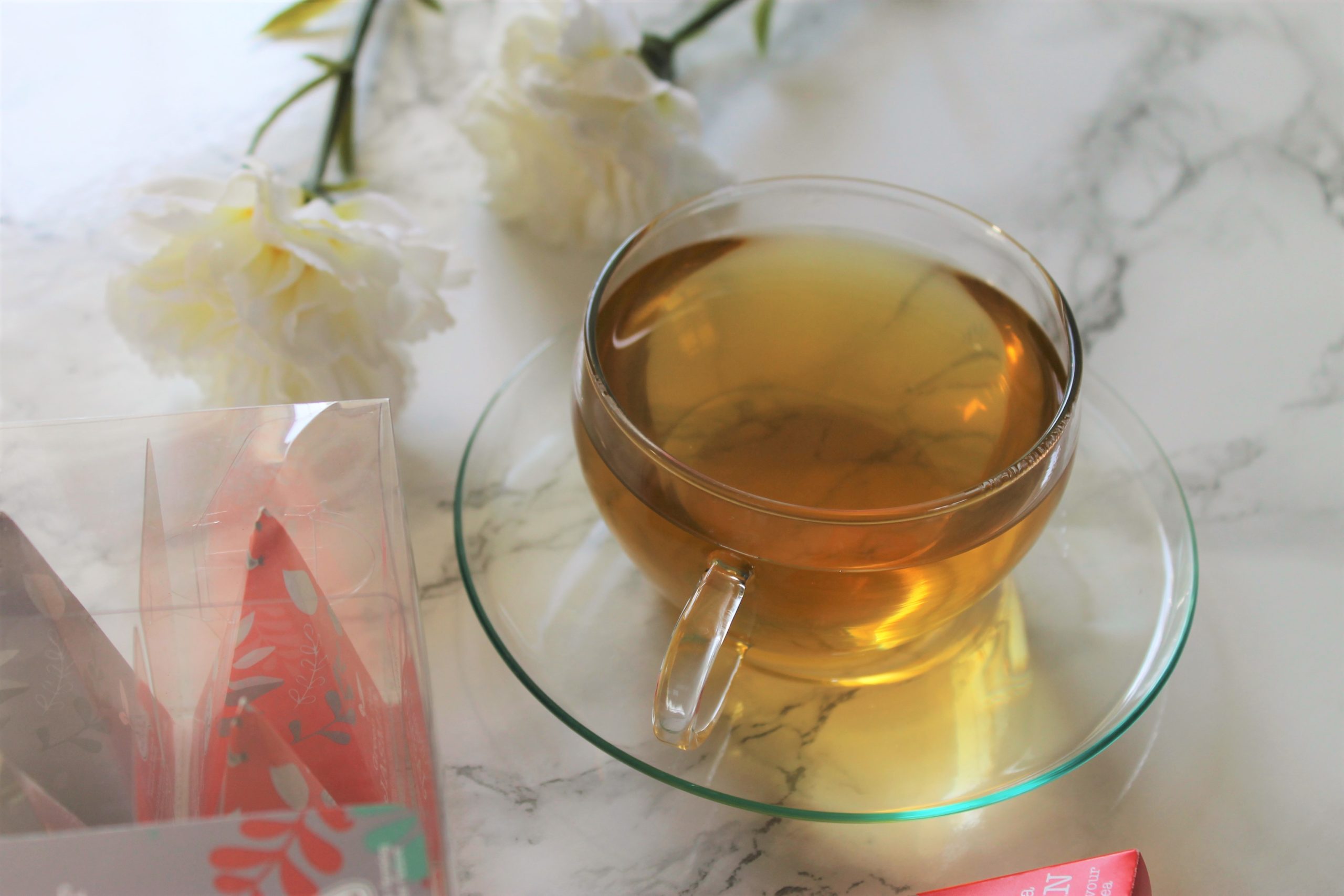 tea with white flowers in teacup