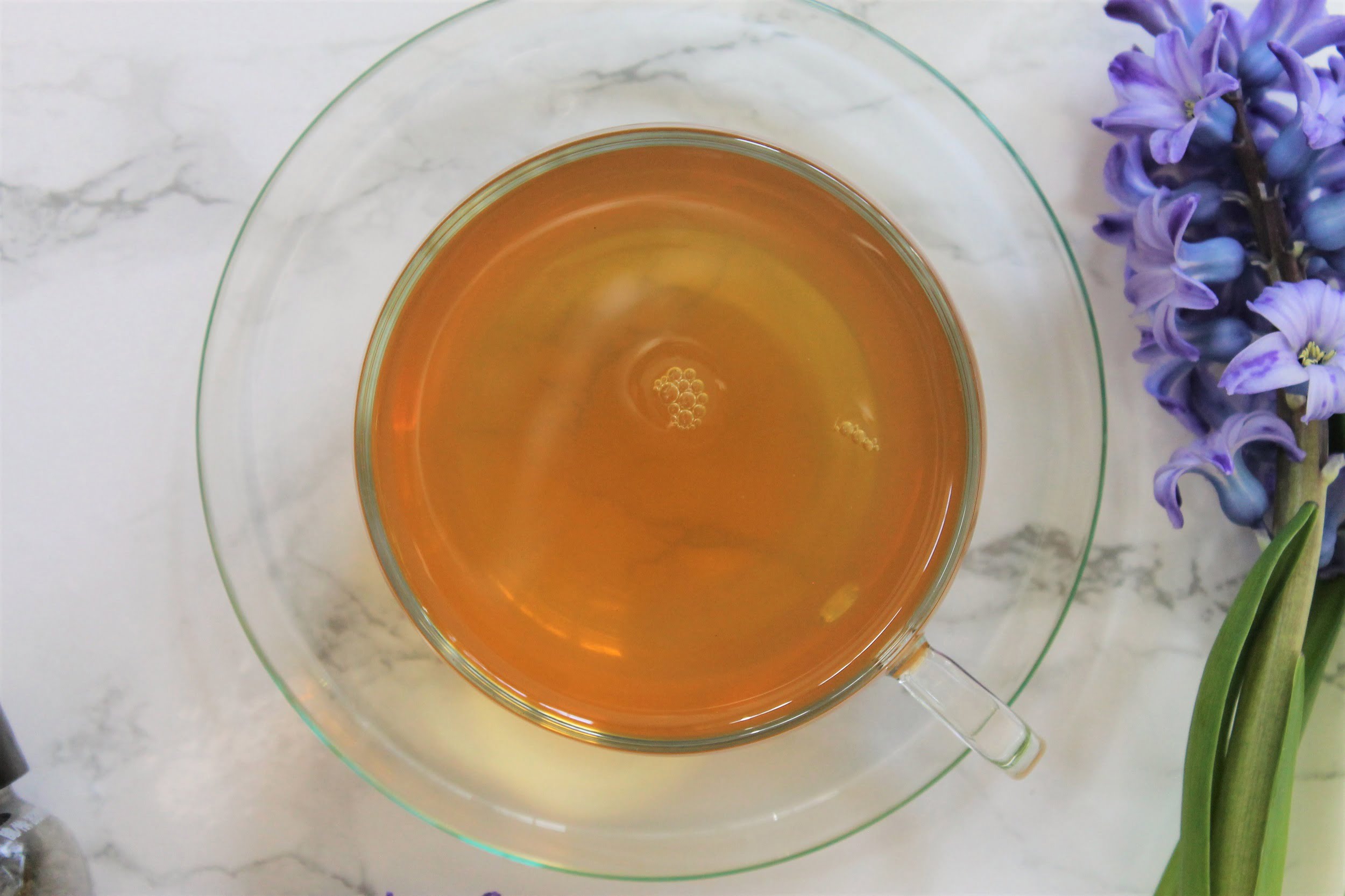 gold green tea in glass teacup