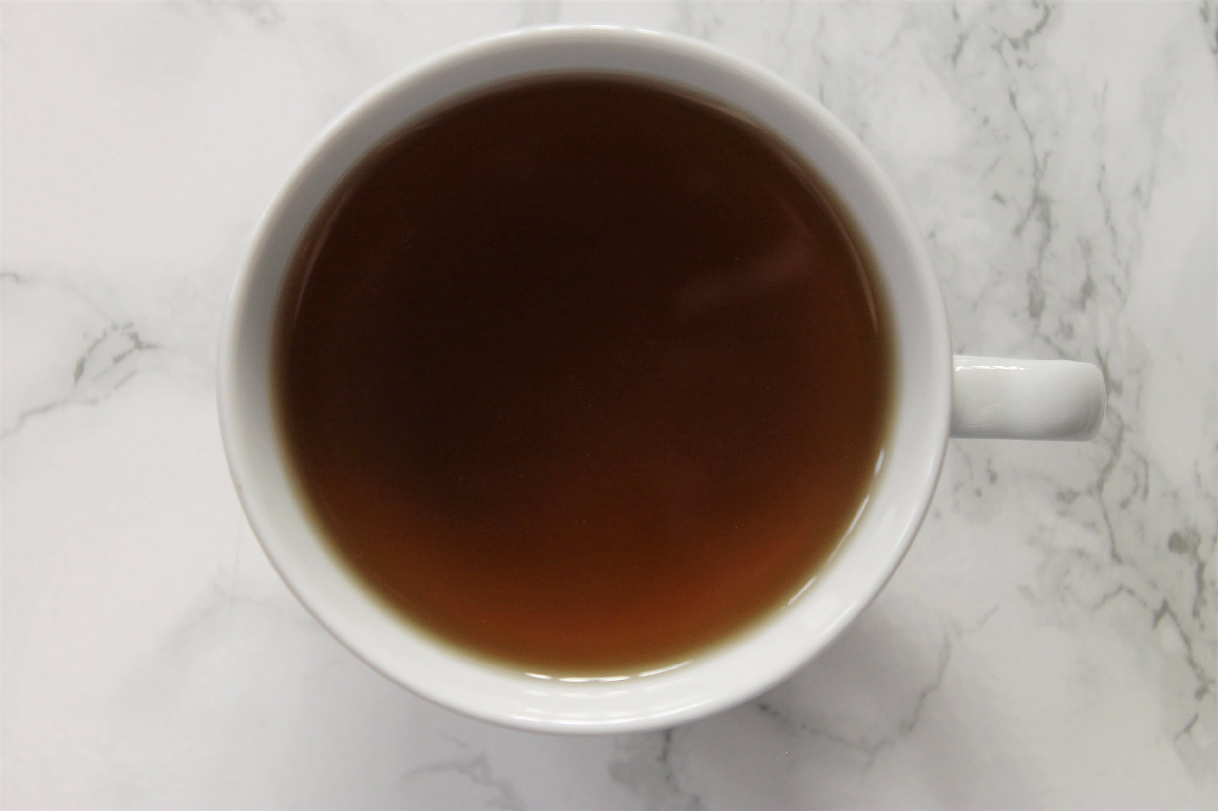 peppermint herbal tea in white teacup