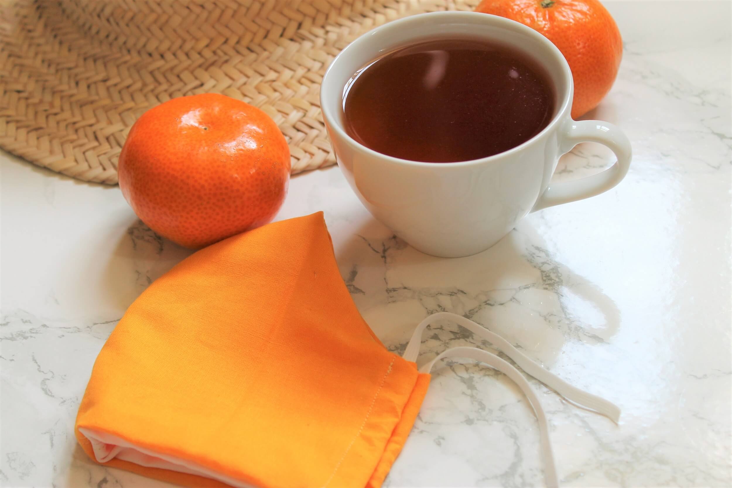 satsuma with orange tea in white teacup