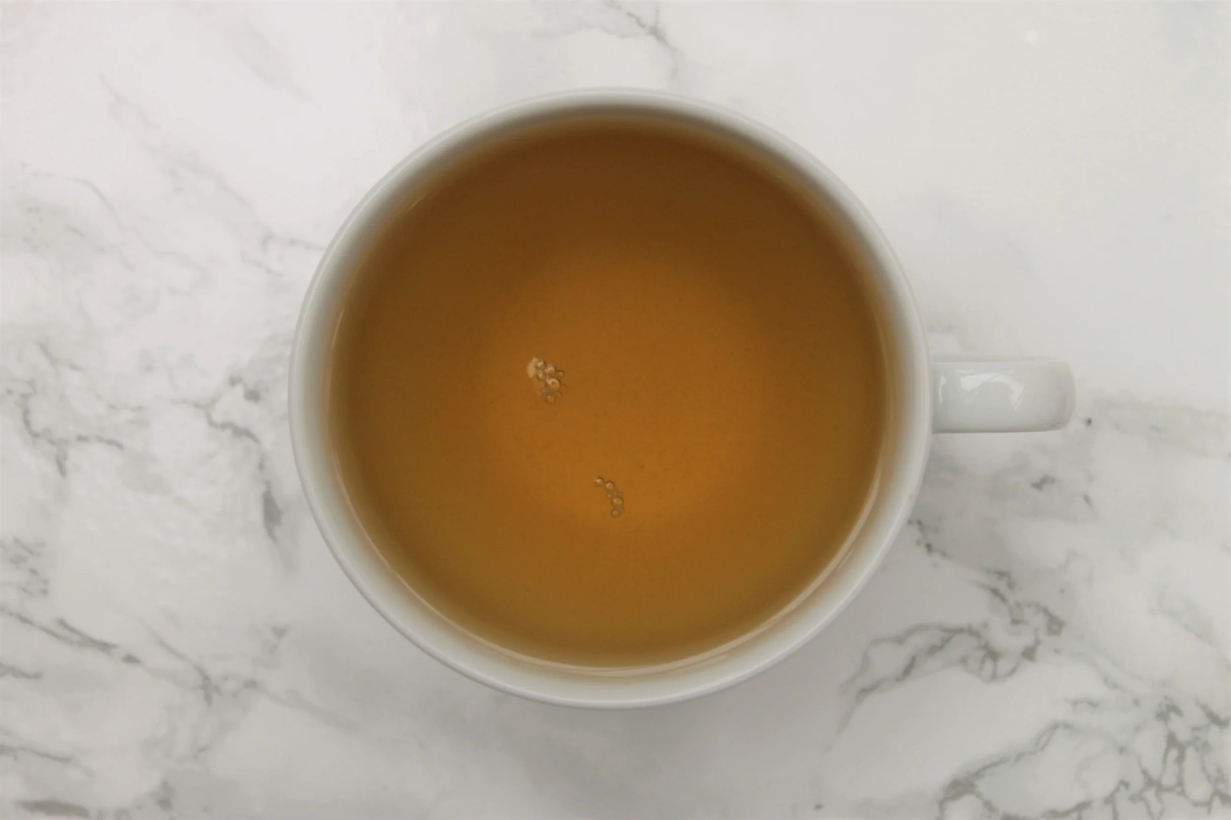 t2 sencha green tea in white teacup