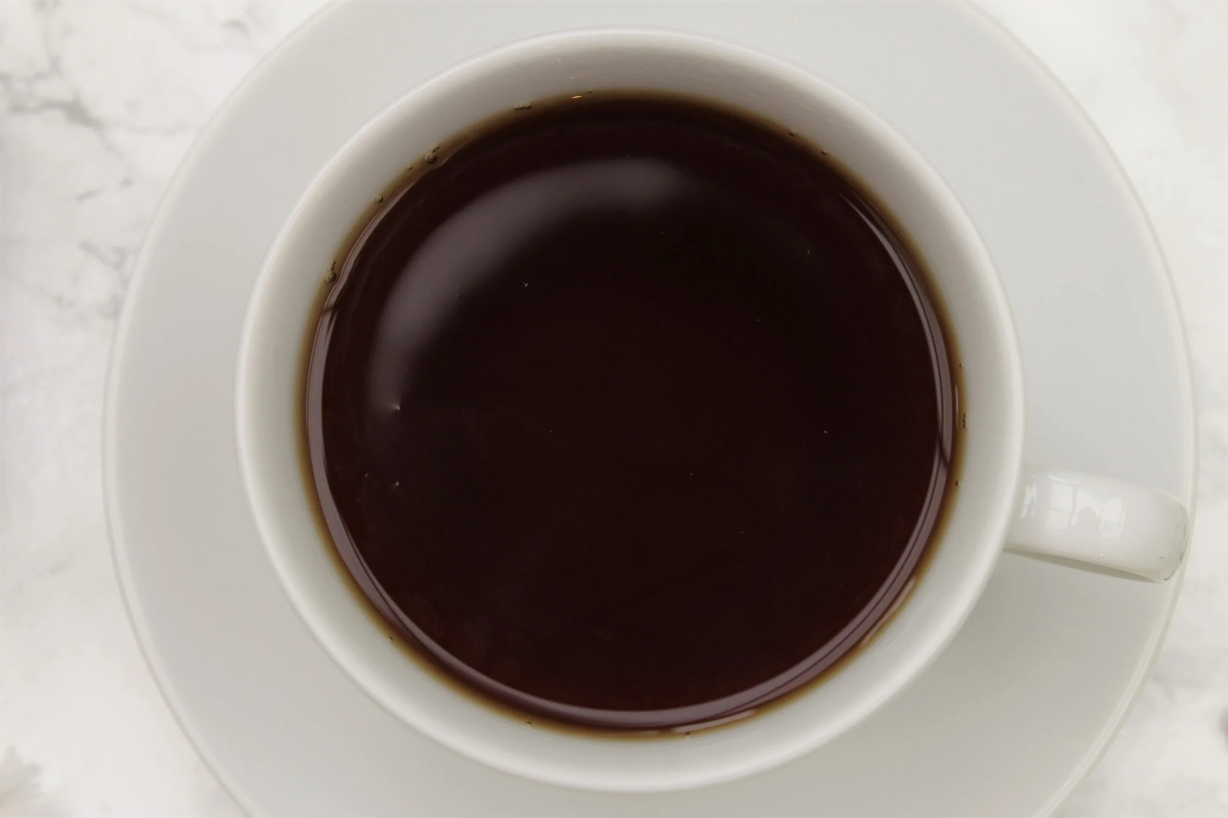 black afternoon tea in teacup