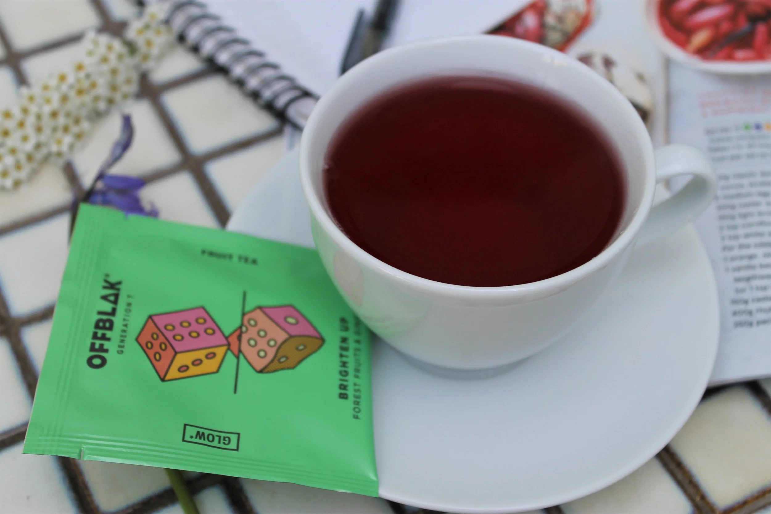 offblak fruit tea in white teacup