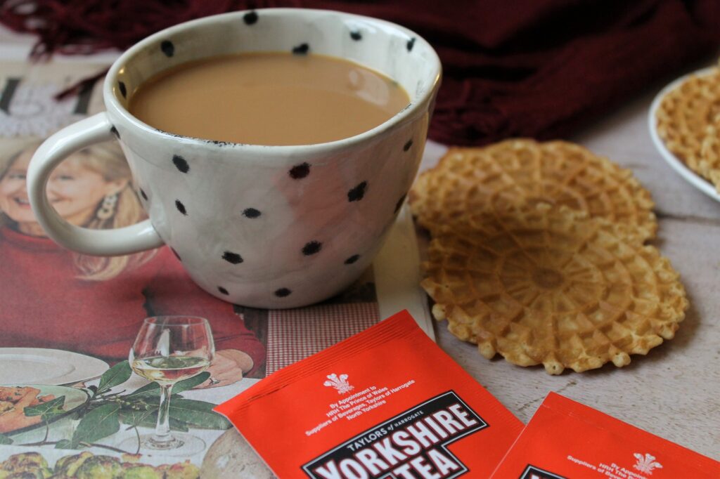 black tea in a teacup with waffles