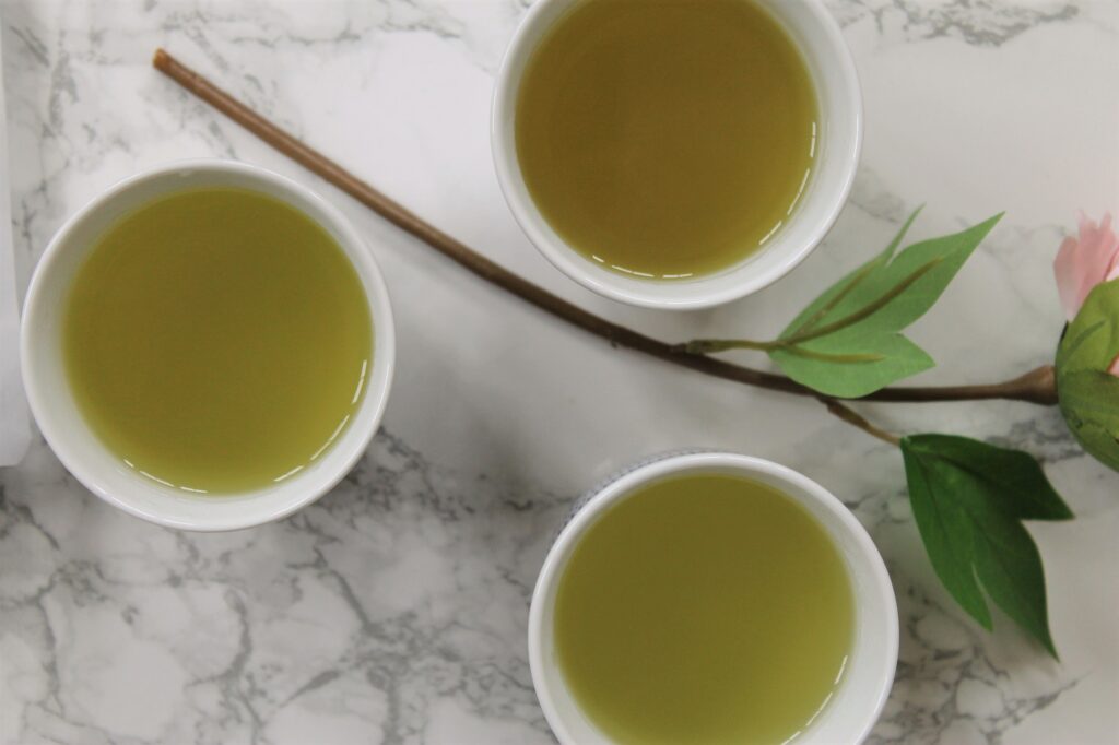 green tea in white porcelain teacups