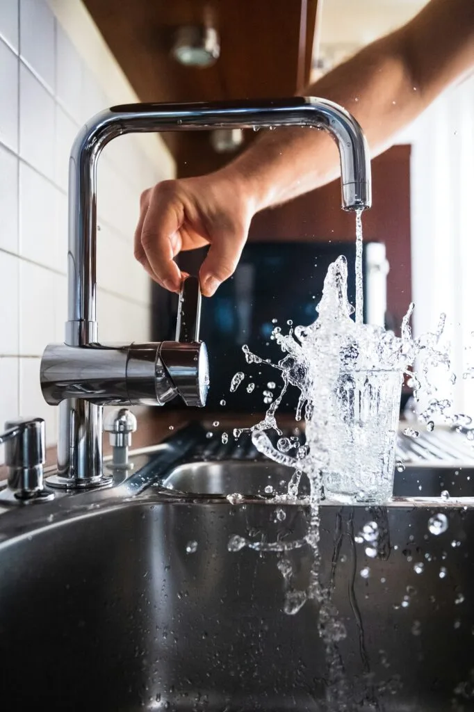 tap water splashing out of glass